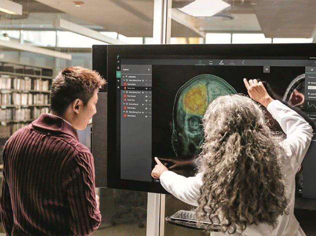 Two healthcare workers looking at an xray image